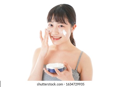 Young Woman Using Cream To The Face