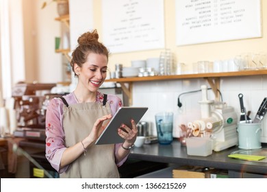 Young woman using digital tablet in coffee shop - Powered by Shutterstock