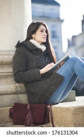 Young Woman Using A Digital Tablet Outside