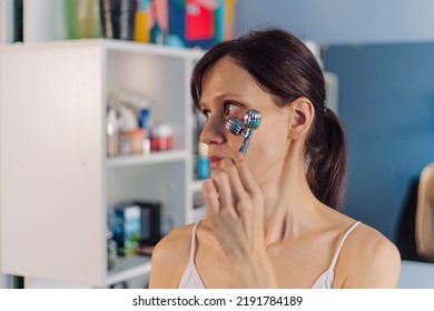 Young Woman Using Facial Roller For Face Massage. Beauty Skin Care