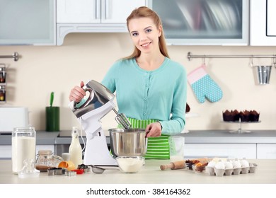 Young Woman Using A Food Processor To Make A Dough