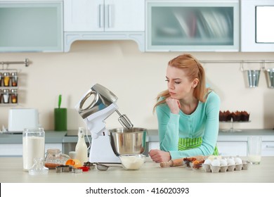 Young Woman Using A Food Processor To Make A Dough