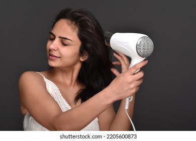 Young Woman Using Hair Dryer 