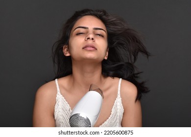 Young Woman Using Hair Dryer 