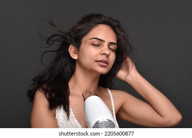 Young Woman Using Hair Dryer 