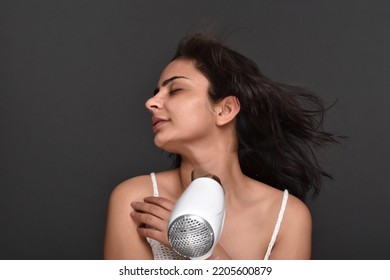 Young Woman Using Hair Dryer 