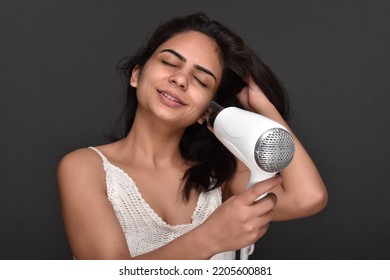 Young Woman Using Hair Dryer 