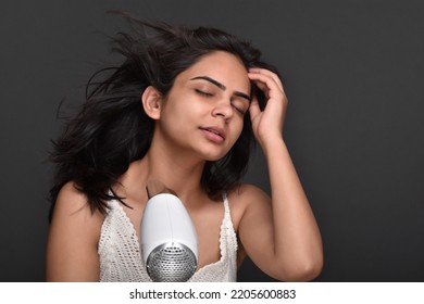 Young Woman Using Hair Dryer 