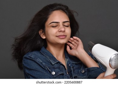 Young Woman Using Hair Dryer 