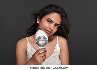 Young Woman Using Hair Dryer 