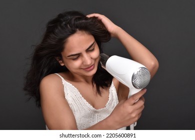 Young Woman Using Hair Dryer 