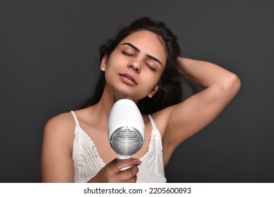 Young Woman Using Hair Dryer 