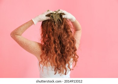 Young Woman Using Henna Hair Dye On Color Background