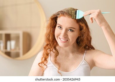 Young Woman Using Henna Hair Dye At Home