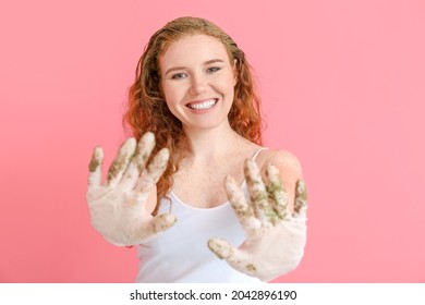 Young Woman Using Henna Hair Dye On Color Background