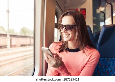 Young Woman Using Her Phone While Riding The Train. 