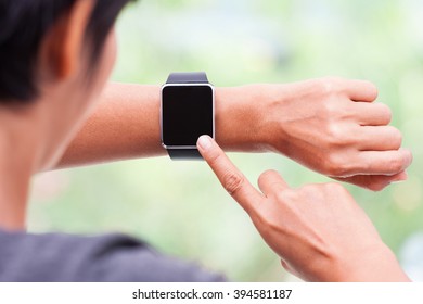 Young Woman Using Her Smart Watch At Home