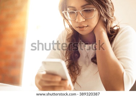 Young woman using her smart phone.
