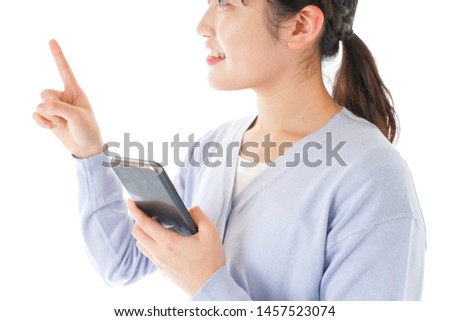 Young woman using IOT appliances with smartphone