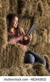 Young Woman Using An Ipad/tablet In A Barn