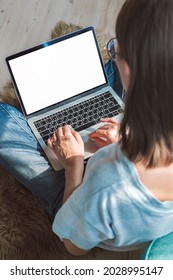 Young Woman Using Laptop Blank Screen To Work, Sitting On The Floor At Home, Flexible Hours And Remote Work