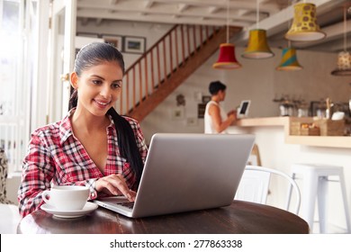 Young Woman Using Laptop In A Cafe