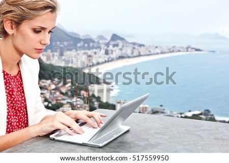 Young woman using laptop, Casa Alto Vidigal, Rio De Janeiro, Brazil