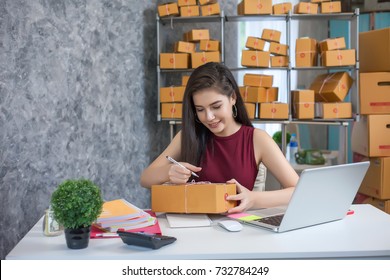 Young woman using laptop computer. Entrepreneurs success in doing business. Shipment Online Sales.