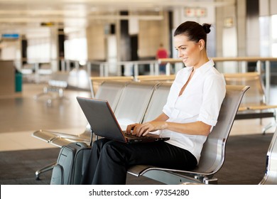 Young Woman Using Laptop Computer At Airport