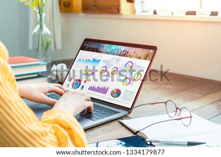 Young woman using a laptop computer. Graphic designer. UX design.