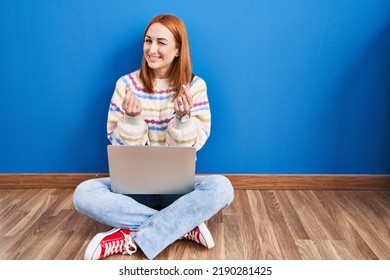 Young Woman Using Laptop At Home Sitting On The Floor Doing Money Gesture With Hands, Asking For Salary Payment, Millionaire Business 