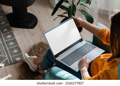 Young woman using laptop to work at home, remote work