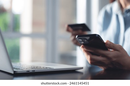 Young woman using mobile smart phone and credit card for digital banking via mobile banking app, internet payment and online shopping, financial technology, global business, e-transaction