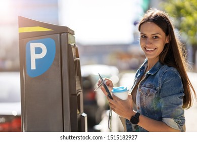 Young Woman Using Parking Machine

