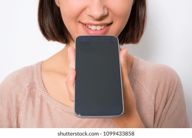 Young woman using phone vocal assistant isolated on white background - Powered by Shutterstock