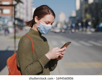 Young Woman Using Smart Phone In The City Wearing Face Mask Protection For Virus Coronavirus Covid 19