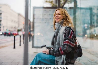 Young woman using smart phone at bus station

