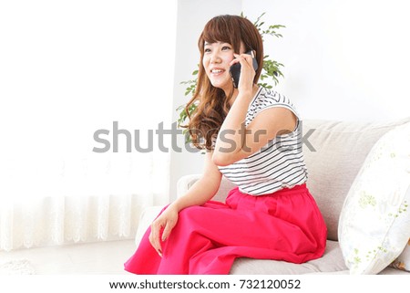 Young woman using smart phone at home