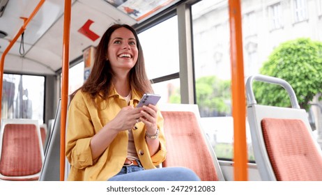 Young woman using smartphone in the city bus - Powered by Shutterstock