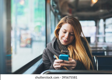 Young Woman Using Smartphone In Public Transport