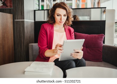 Young woman using tablet computer in the cafe. Communication, technology, leisure and people concept - happy young woman or teenage girl with tablet pc computer street cafe.