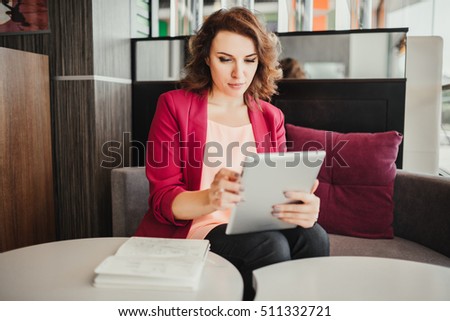 Young woman using tablet computer in the cafe. Communication, technology, leisure and people concept - happy young woman or teenage girl with tablet pc computer street cafe.