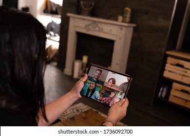 Young Woman Using A Tablet To Connect With Her Family And Friends During Quarantine For Covid 19