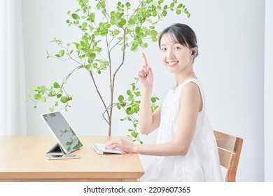  young woman using tablet PC - Shutterstock ID 2209607365