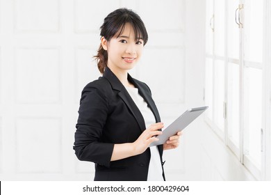 A Young Woman Using A Tablet Terminal Taken In The Studio