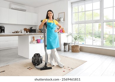 Young woman with vacuum cleaner  in kitchen