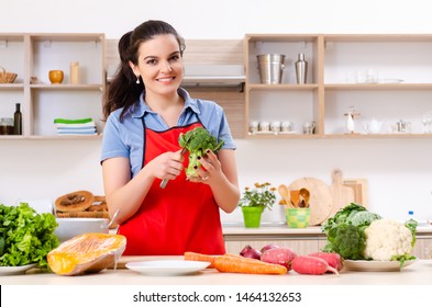 Young woman with vegetables in the kitchen 