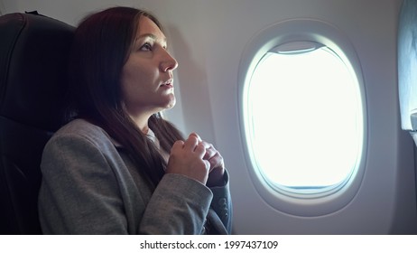 Young woman is very afraid of flying on an airplane. - Powered by Shutterstock