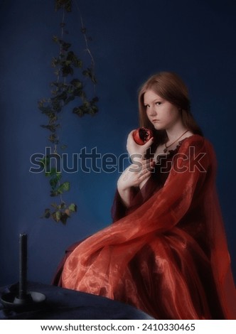 young woman in vintage dress with pomegranate on blue background