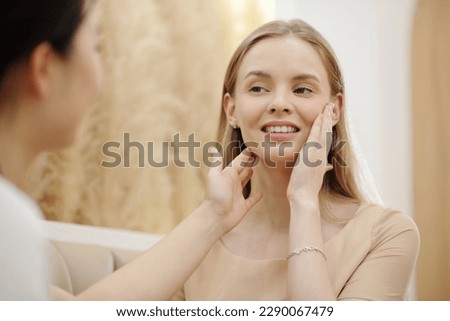 Young woman visiting esthetician to get skicare treatment ストックフォト © 